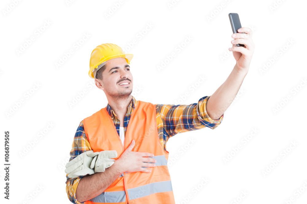Cheerful engineer with yellow helmet taking a selfie Cheerful engineer with yellow helmet taking a selfie