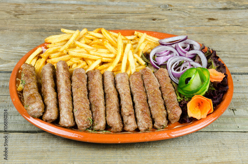 Kebabs with onions and french fries photo