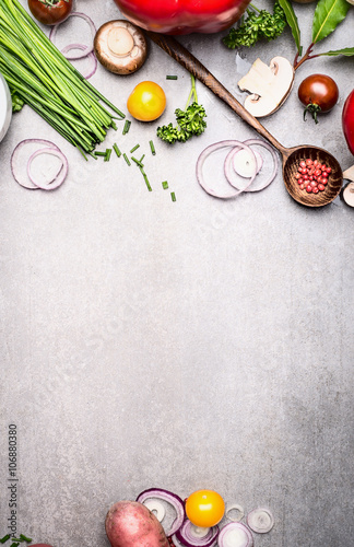 Healthy cooking with fresh vegetables and seasoning ingredients on rustic stone background, top view, place for text., frame. Healthy lifestyle and diet food concept.