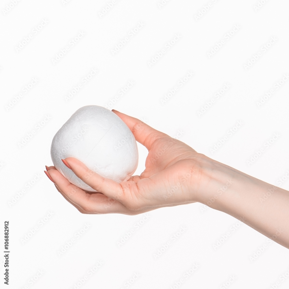 The female hand holding white blank styrofoam oval The female hand holding white blank styrofoam oval