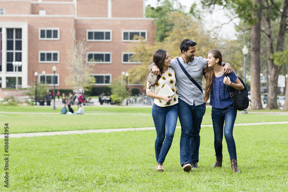 Smiling students walking on campus Smiling students walking on campus