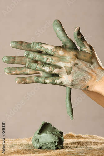 hands of women working with blue clay, closeup