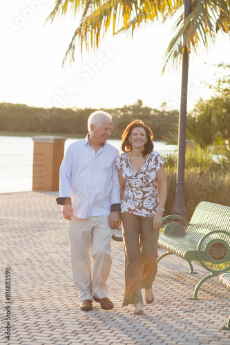 Older Caucasian couple holding hands outdoors photo