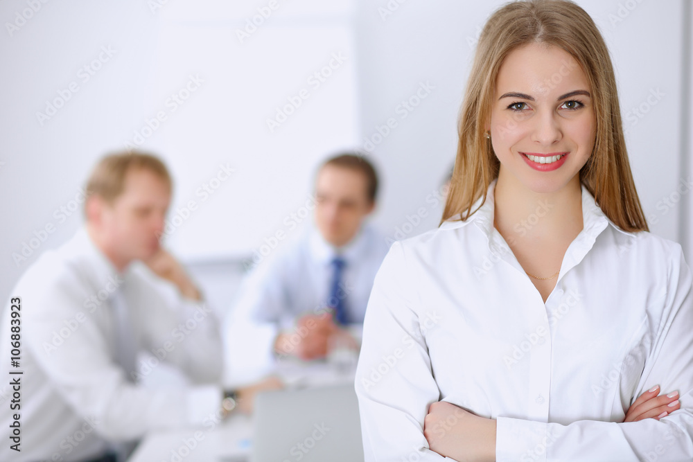 Beautiful business woman on the background of business people during meeting Beautiful business woman on the background of business people during meeting