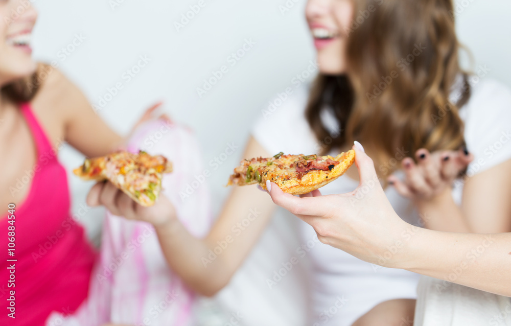happy friends or teen girls eating pizza at home happy friends or teen girls eating pizza at home