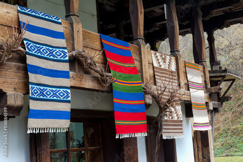 Traditional Bulgarian woven fabrics on the balcony of the wooden house in Etara village, Bulgaria photo