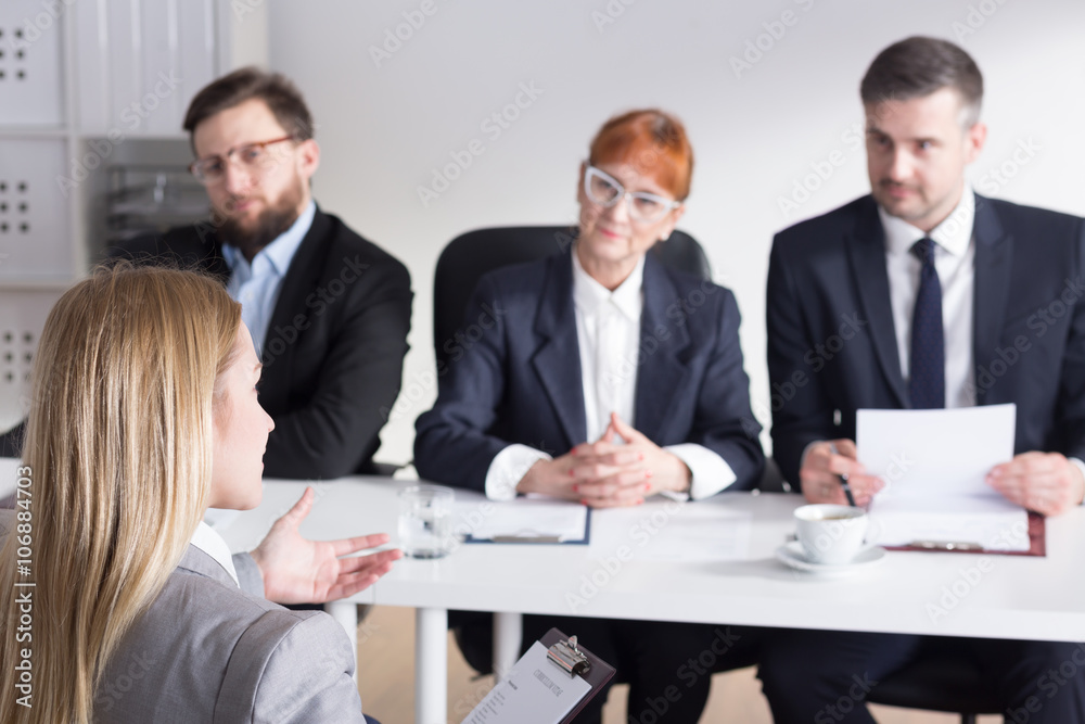 Three businesspeople during job interview with intern Three businesspeople during job interview with intern