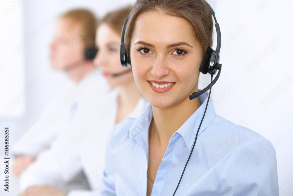 Call center. Focus on beautiful woman in headset Call center. Focus on beautiful woman in headset