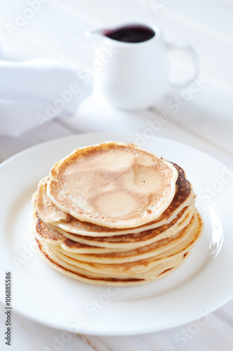 Light breakfast. Fresh pancakes on white plate with berry jam