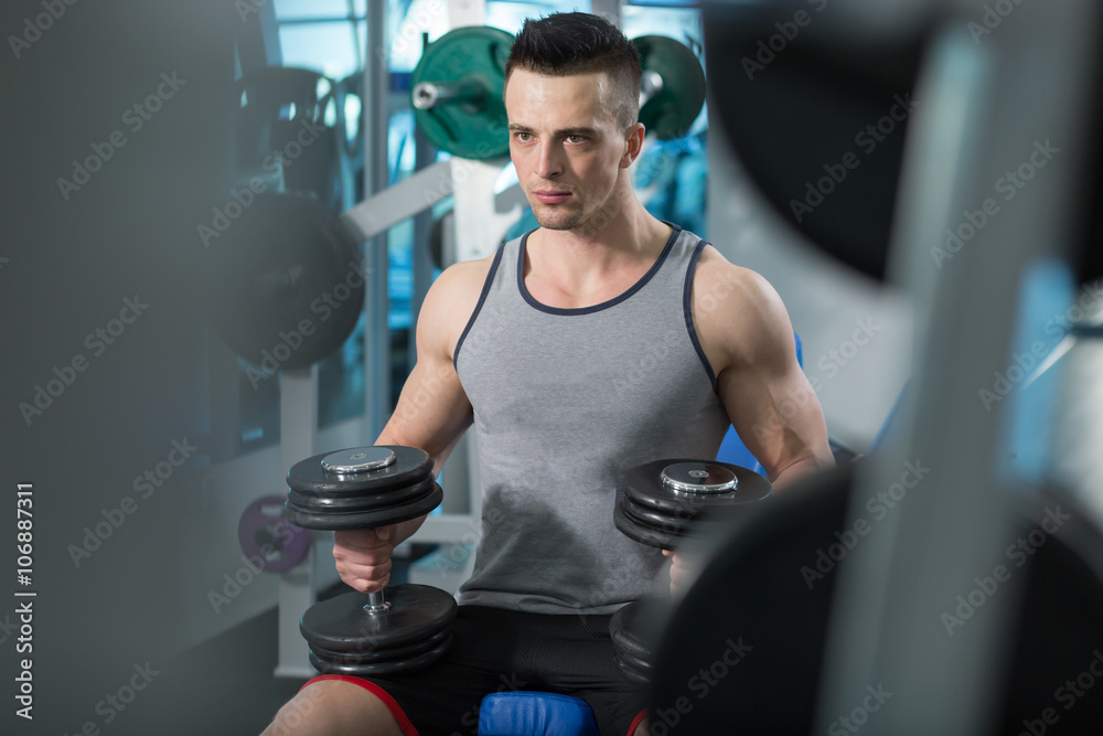 Muscular Young Man Doing Heavy Weight Exercise For Biceps With D Muscular Young Man Doing Heavy Weight Exercise For Biceps With D