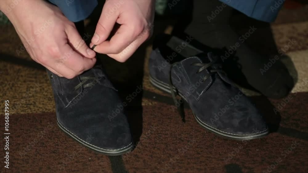 men tying suede shoes laces men tying suede shoes laces
