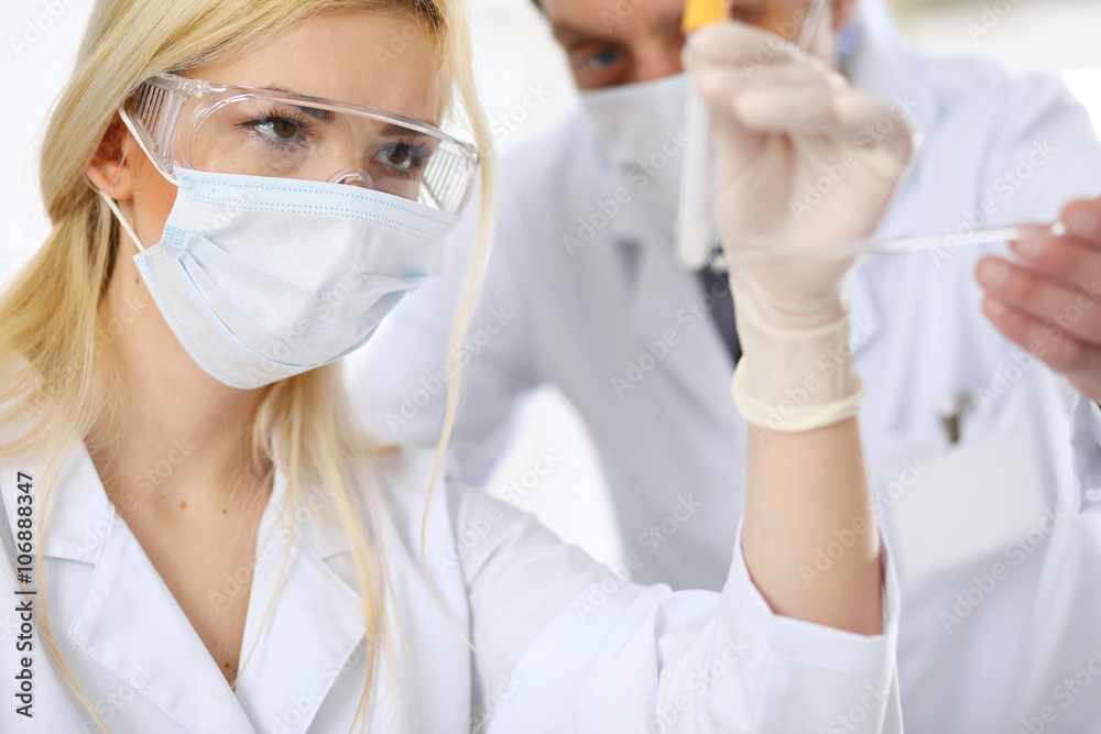 Scientific research team with clear solution in laboratory Scientific research team with clear solution in laboratory