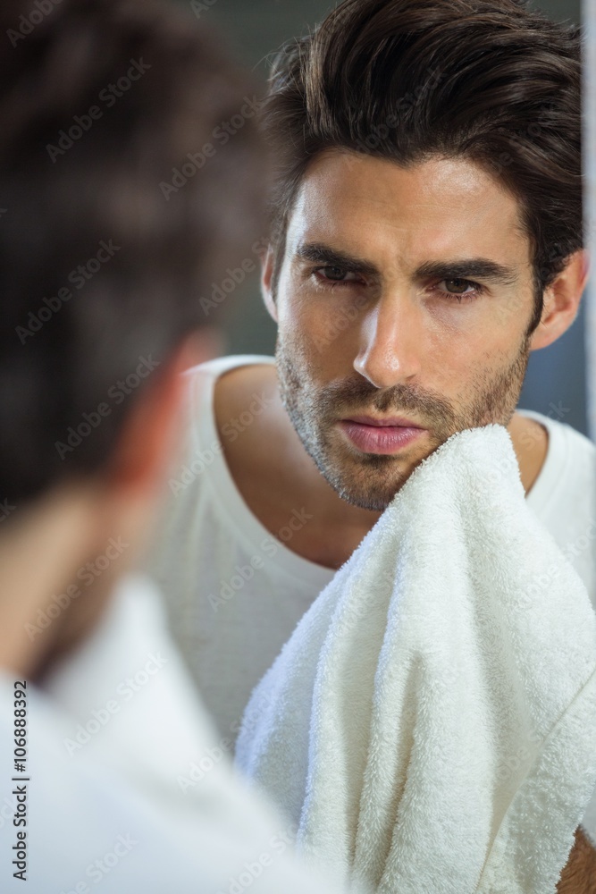 Fototapeta premium Man wiping his face with napkin