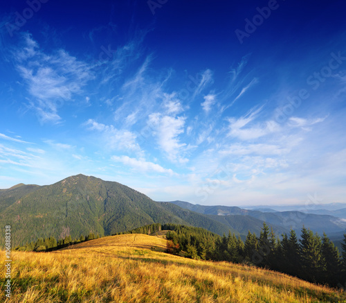 Mountain landscape with blue clouds