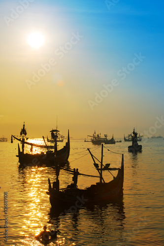 Commercial fishing boats and sunrise in Muncar, a fishing village in east Java,Banyuwangi