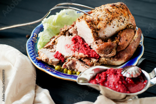  meat , home baked ham or cold boiled pork with spices , lettuce, green peas and sweet and sour berry sauce on a wooden background