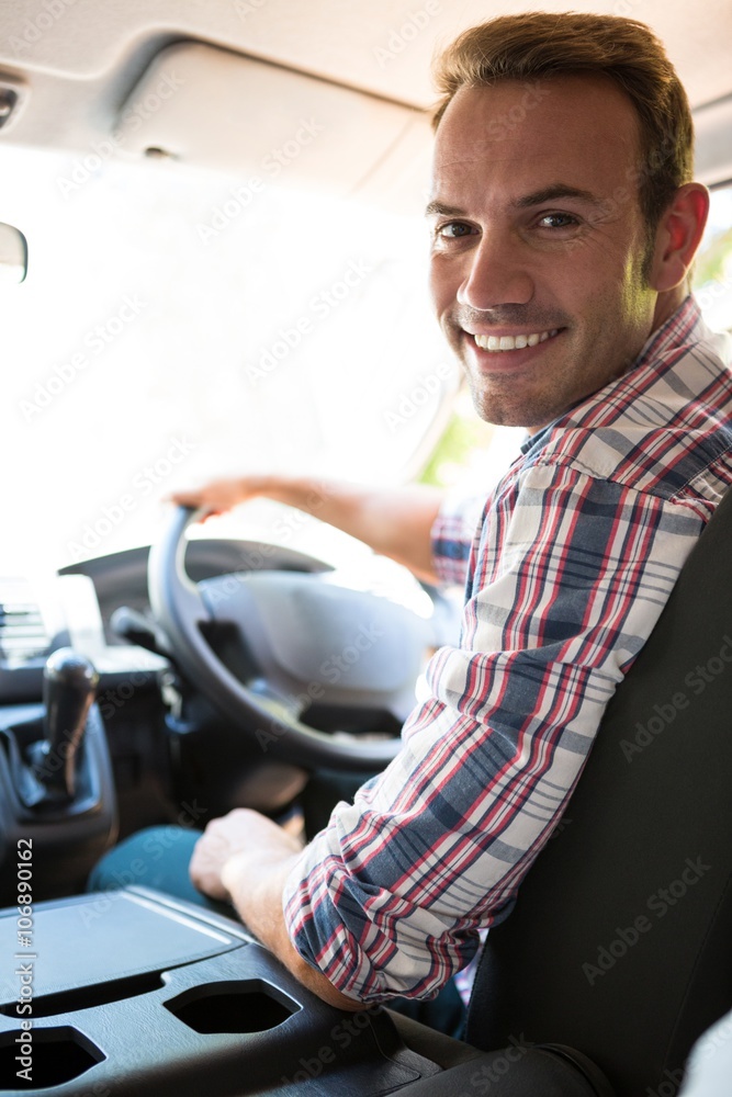 Young man looking at camera while sitting on cars front seat Young man looking at camera while sitting on cars front seat