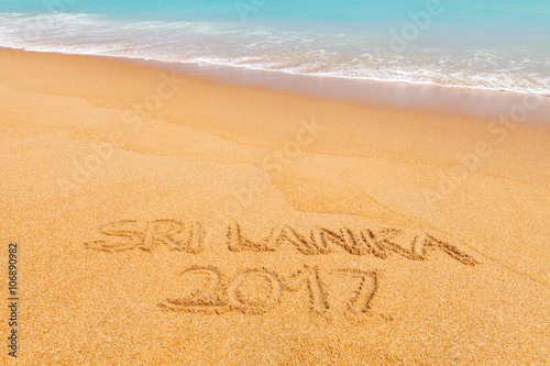 Inscription "Sri Lanka 2017" made on beautiful beach by the blue sea