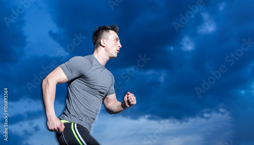 healthy man jogging in the city at early morning in night