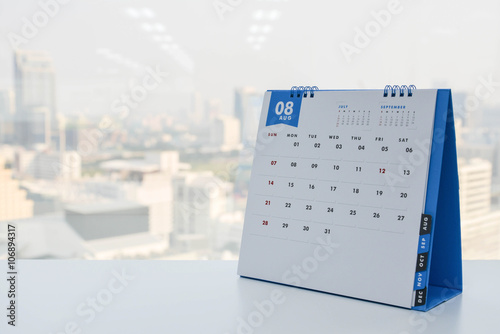 Calendar of August on the white table with city view background