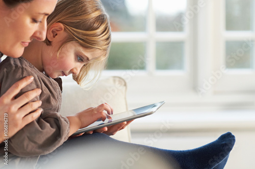 Mother and daughter using digital tablet photo