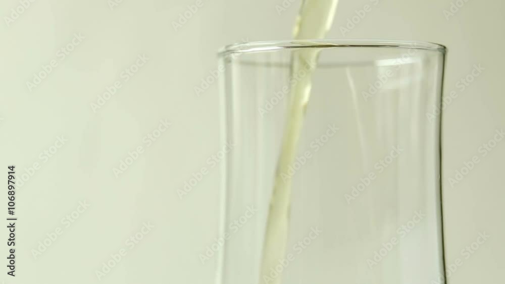 Pour beer into a glass on white background Pour beer into a glass on white background