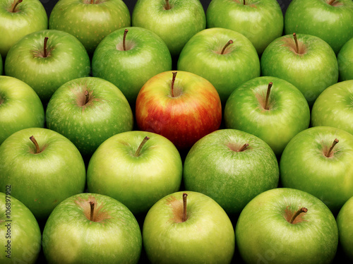 Group of green apples with one red apple