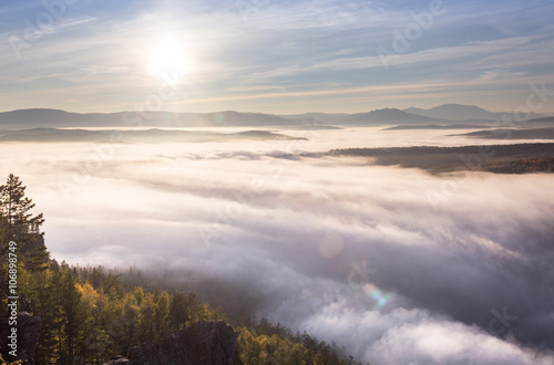 Great view of the foggy valley with sunrise. South Ural mountain © EdNurg