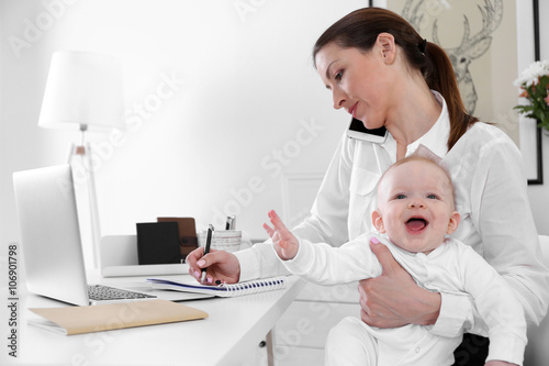 Businesswoman with baby boy...