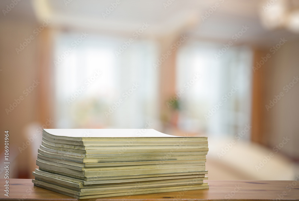 stack of old magazines on wooden table stack of old magazines on wooden table