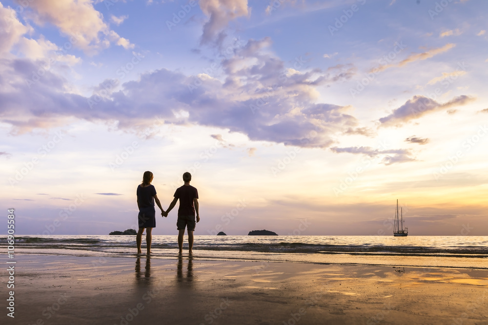Happy couple having a romantic walk near the sea