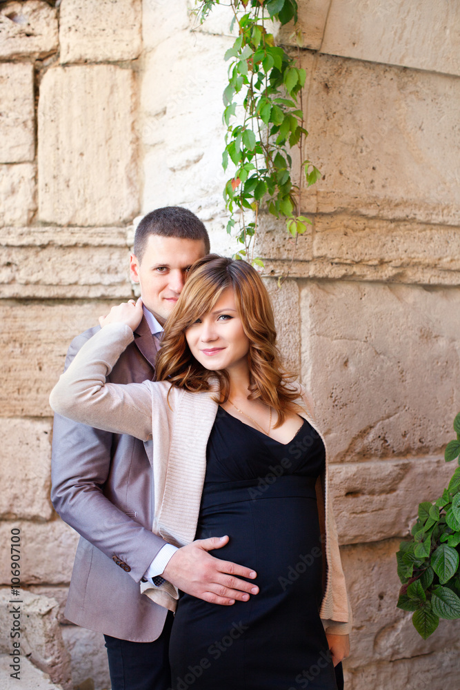 Man tenderly embraced Pregnant Woman