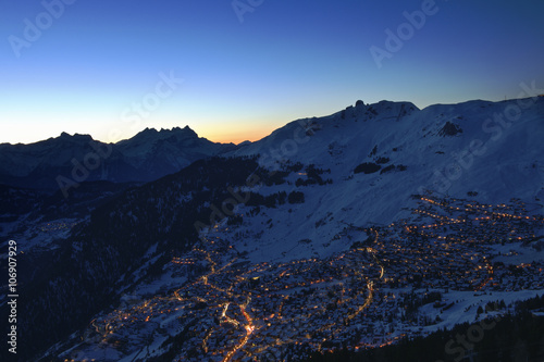 Town in mountains at night, Verbier, Switzerland photo
