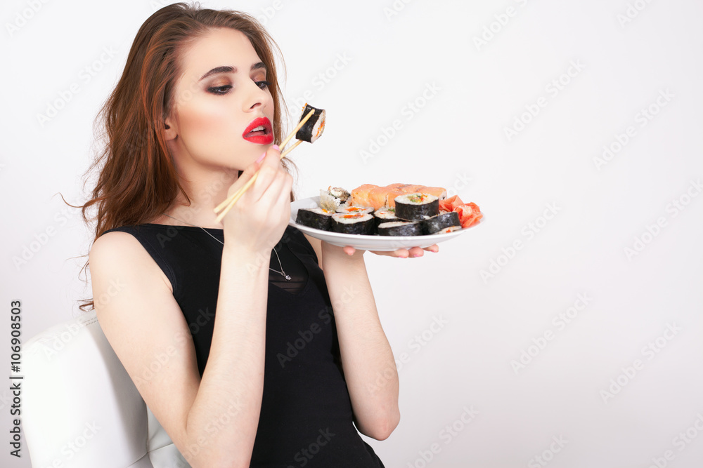 Young woman eating sushi at Japanese restaurant Young woman eating sushi at Japanese restaurant
