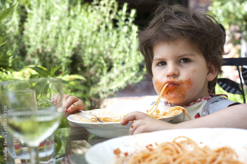 Portrait of messy male toddler eating spaghetti Portrait of messy male toddler eating spaghetti