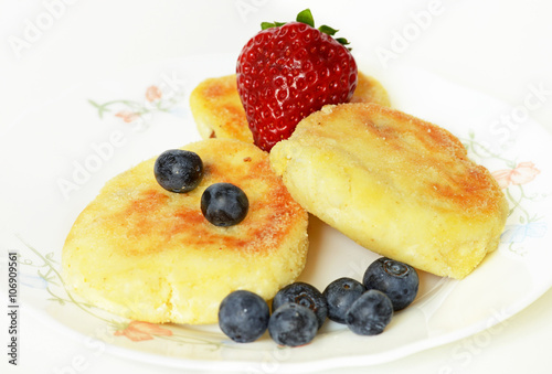 Delicious homemade cheese pancakes with blueberries and strawberries