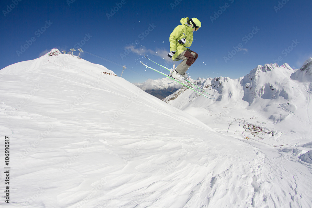 Flying skier on mountains. Extreme winter sport.