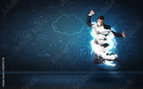Happy business man jumping with storm cloud around him