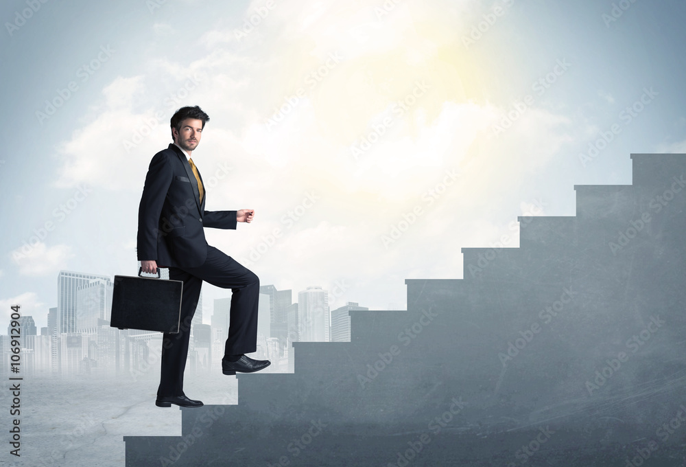 Businessman climbing up a concrete staircase concept Businessman climbing up a concrete staircase concept