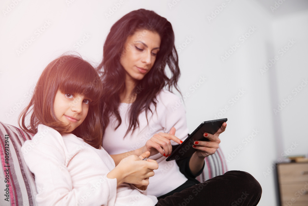 Mother and daughter looking at digital tablet Mother and daughter looking at digital tablet
