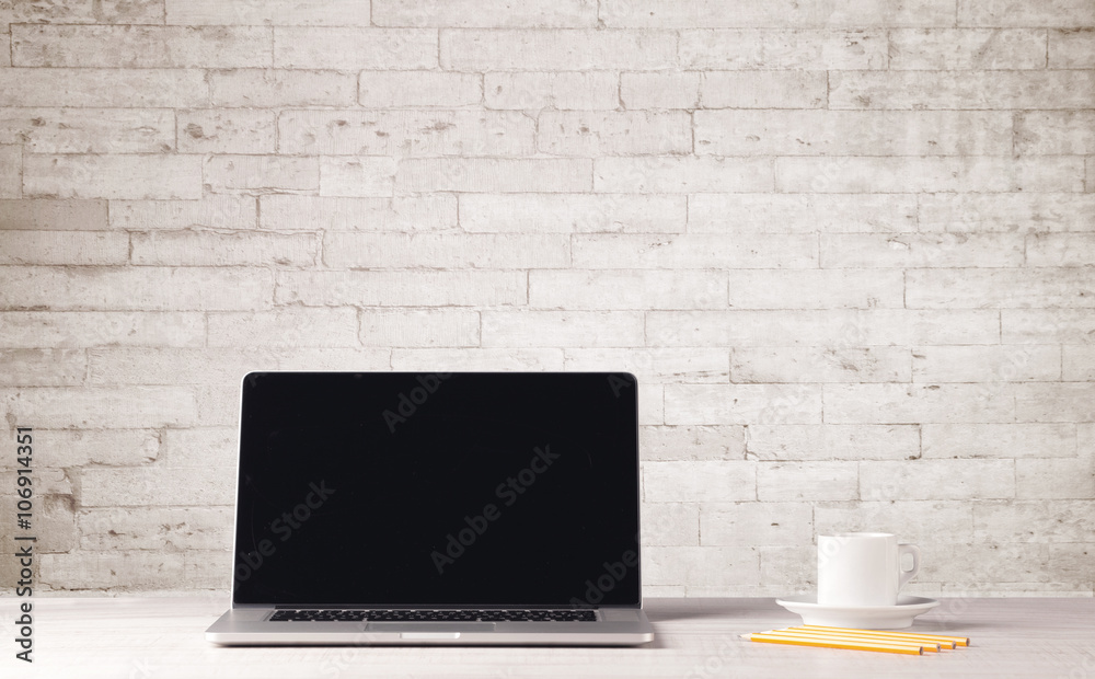 Fototapeta premium Business laptop with white brick wall