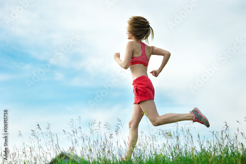 Young woman running summer park rural road. Outdoor exercises. J