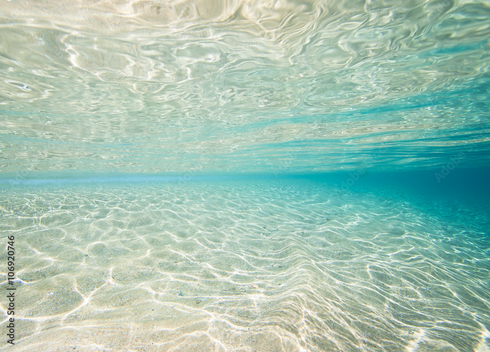 Underwater shot of the sea sandy bottom at sunny day