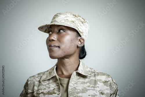 Studio portrait of confident female soldier looking sideways photo