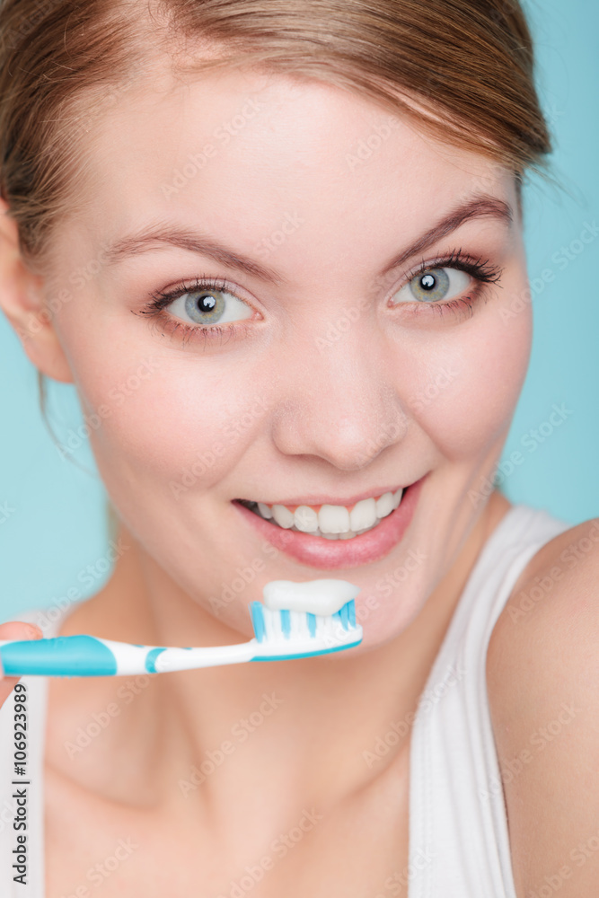 woman holds toothbrush with toothpaste cleaning teeth woman holds toothbrush with toothpaste cleaning teeth
