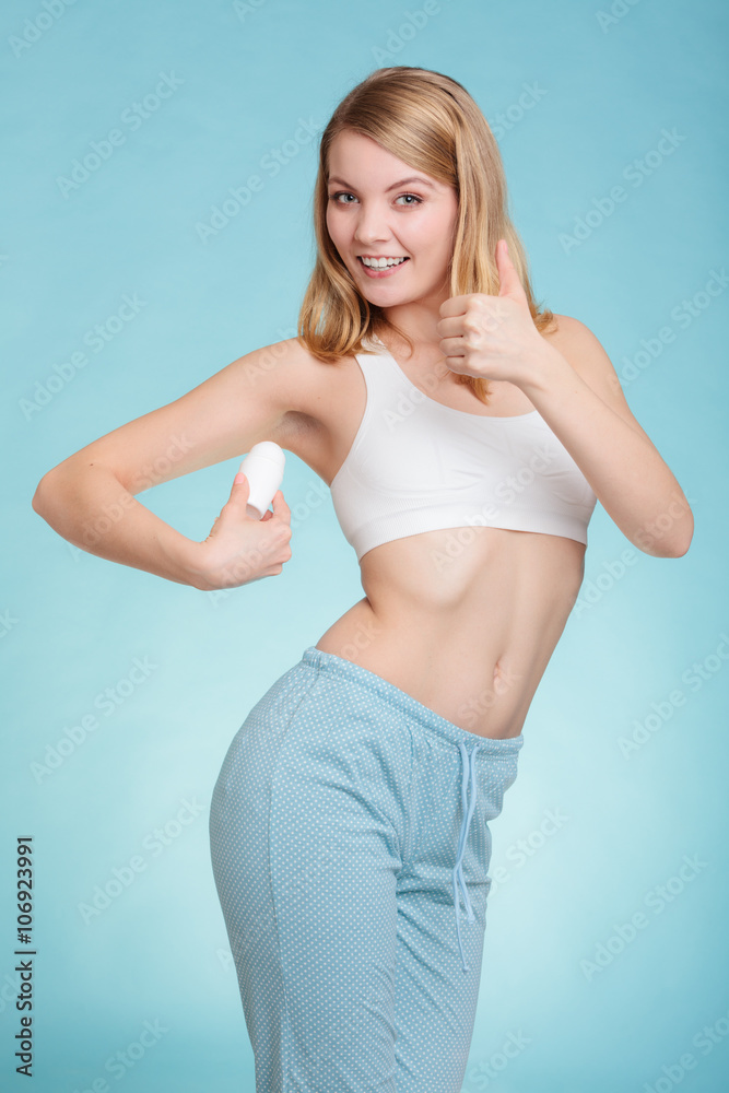 Girl applying stick deodorant in armpit. Girl applying stick deodorant in armpit.
