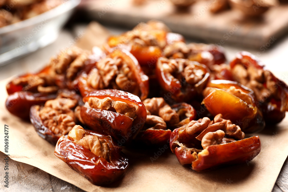 Walnut and date fruit on wooden table, close-up Walnut and date fruit on wooden table, close-up