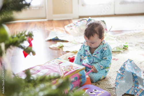 Baby girl opening christmas presents