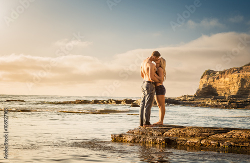 Young couple kissing on rocks, Sunset Cliffs, San Diego, California, USA