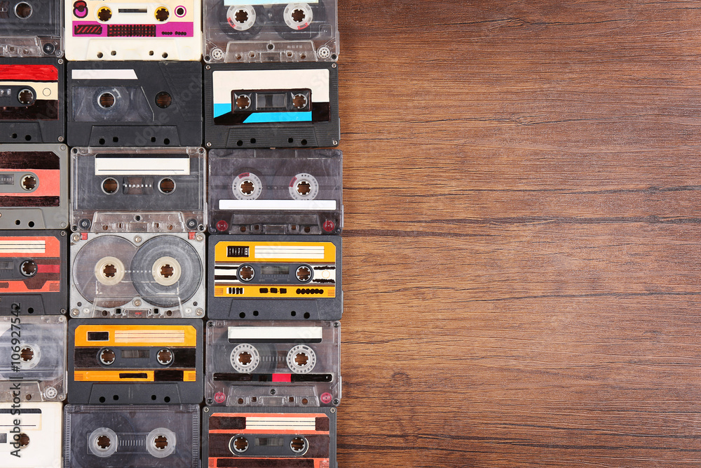 Obraz premium Collection of audio cassettes on wooden table background, copy space